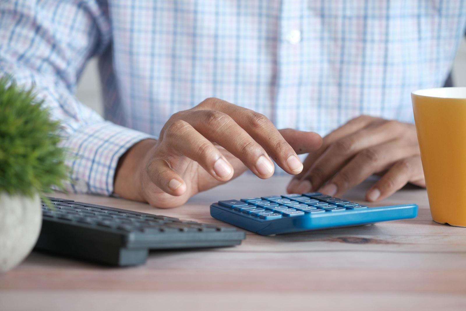 Business figures being worked through on a calculator