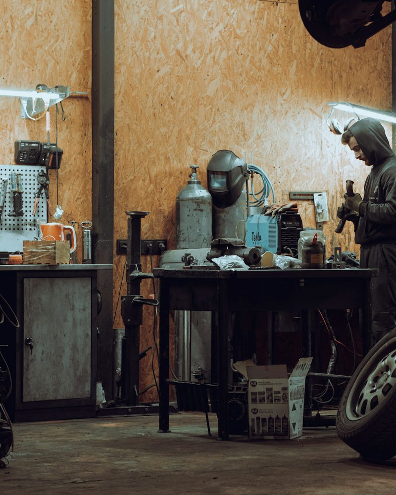 Mechanic working at a bench in a vehicle repair garage